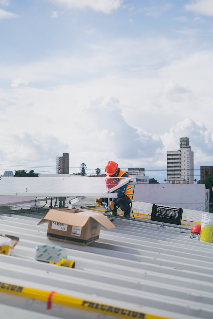 why-choose-us-02 Solar technician working on rooftop installation of photovoltaic panels on a sunny day.